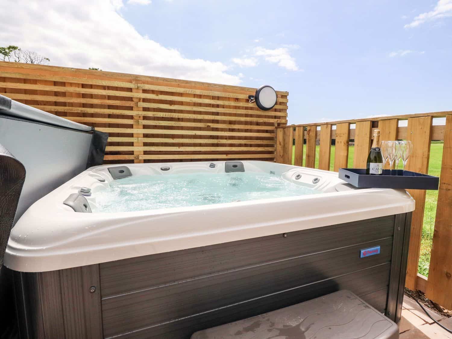 Outdoor hot tub with countryside views at Box Tree Escapes