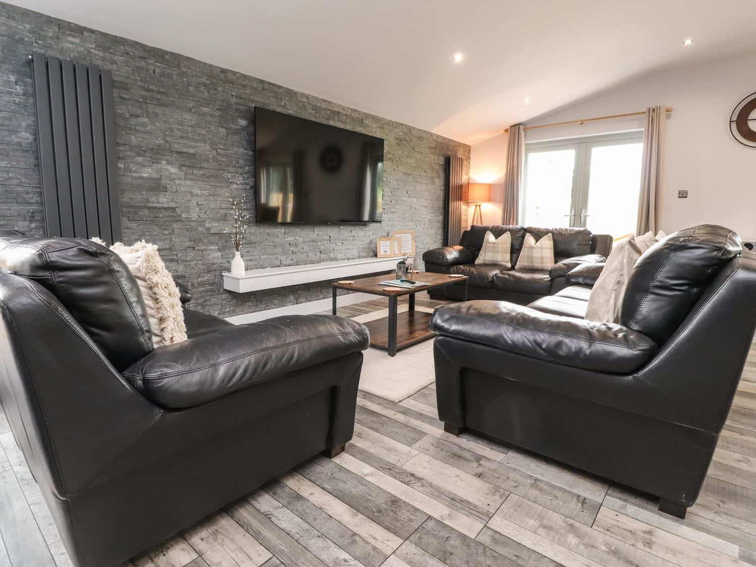 Spacious interior with leather sofas at Box Tree Escapes