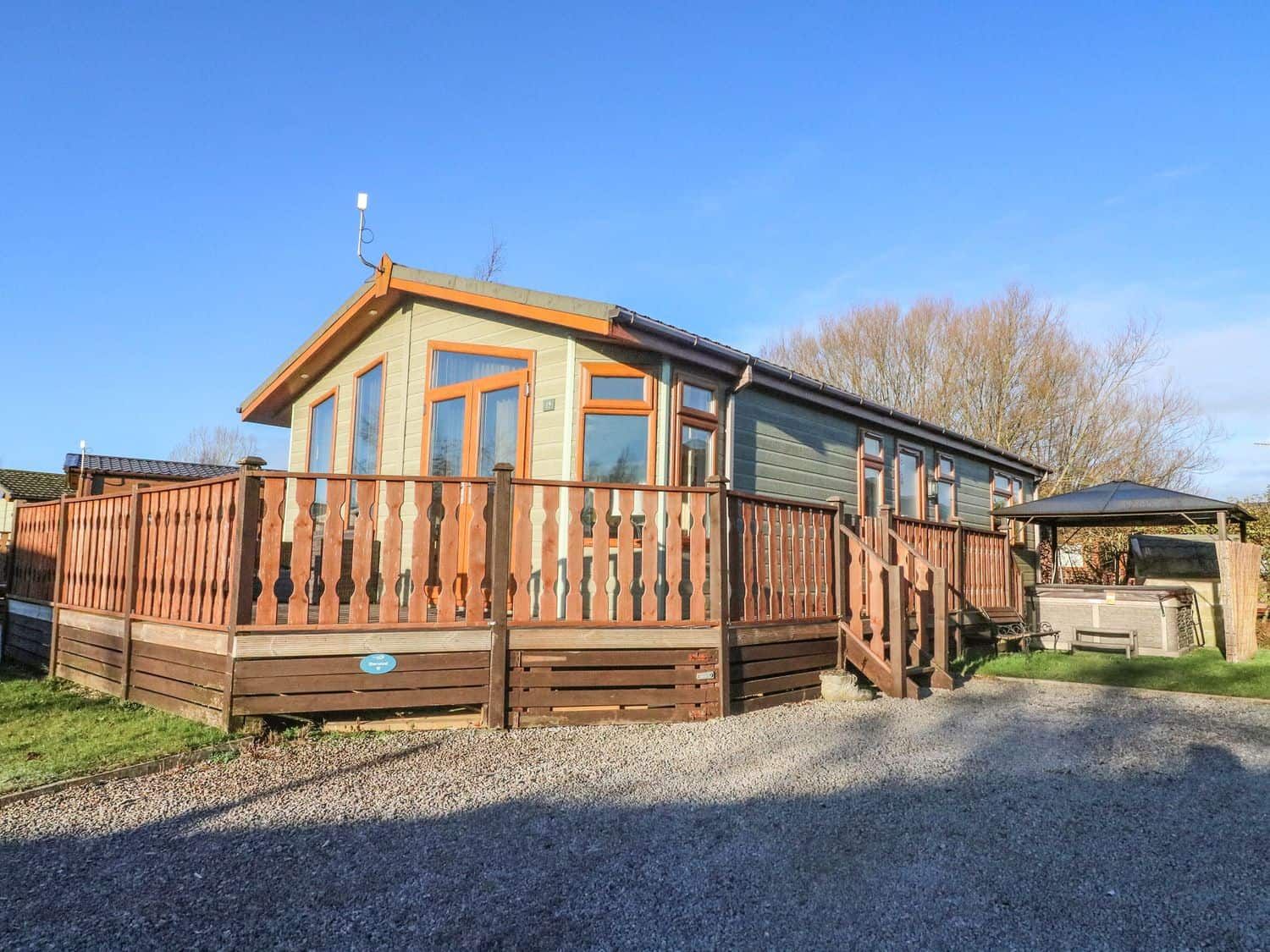 Dream Catcher Lodge exterior with wooden deck and hot tub