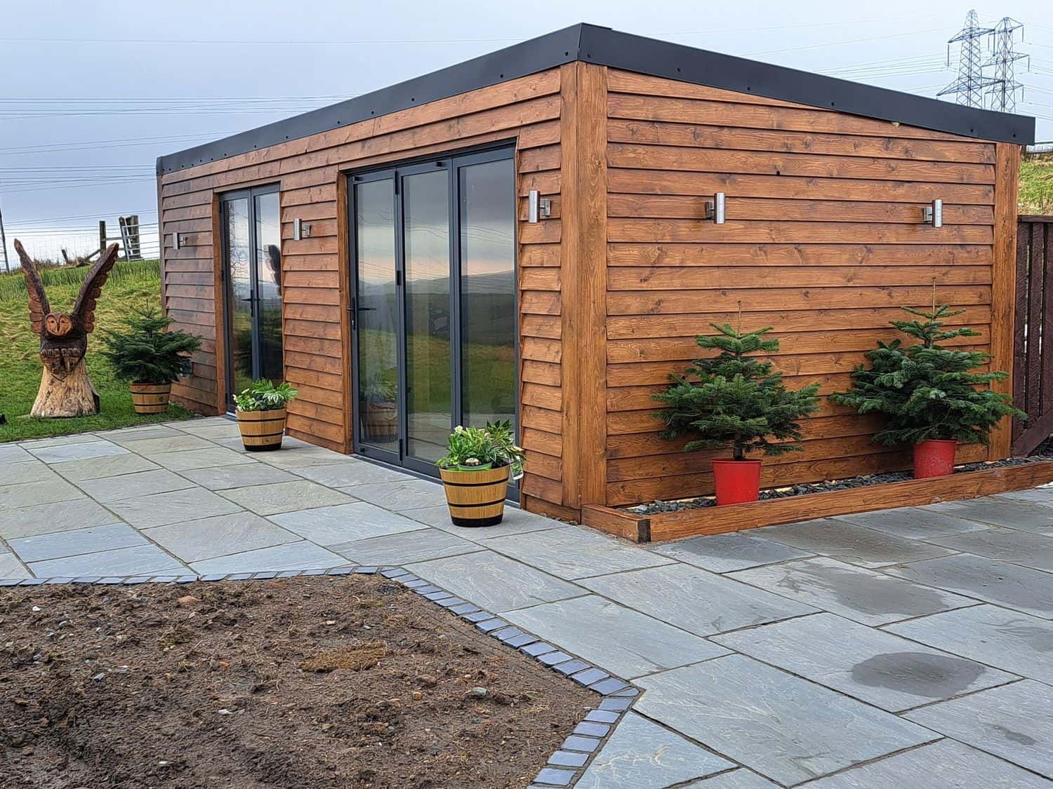 Height End Farm Log Cabin timber exterior with glass sliding doors in Rossendale