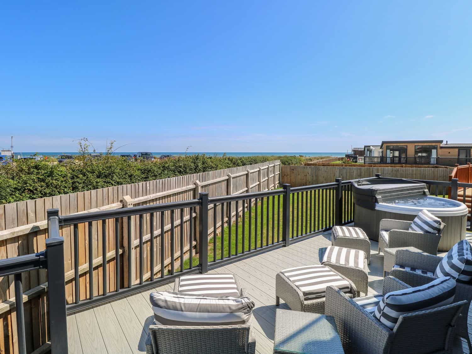 Private deck with hot tub and seating overlooking the North Sea