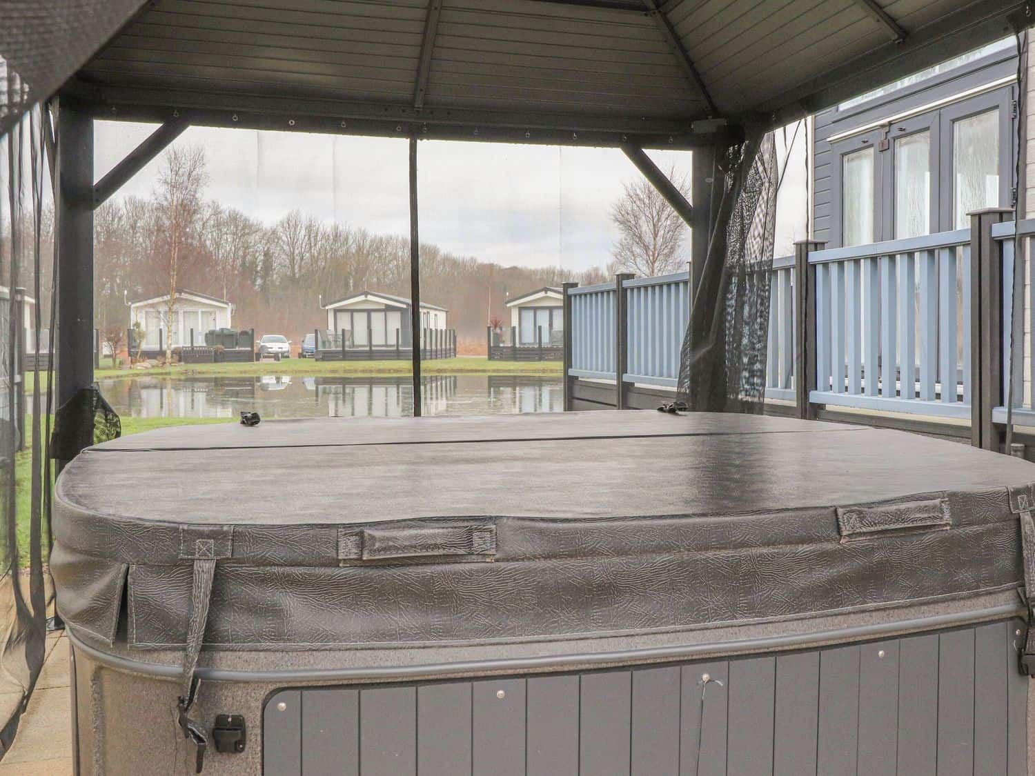 Sheltered hot tub for all-weather relaxation at Tiptoes Lodge
