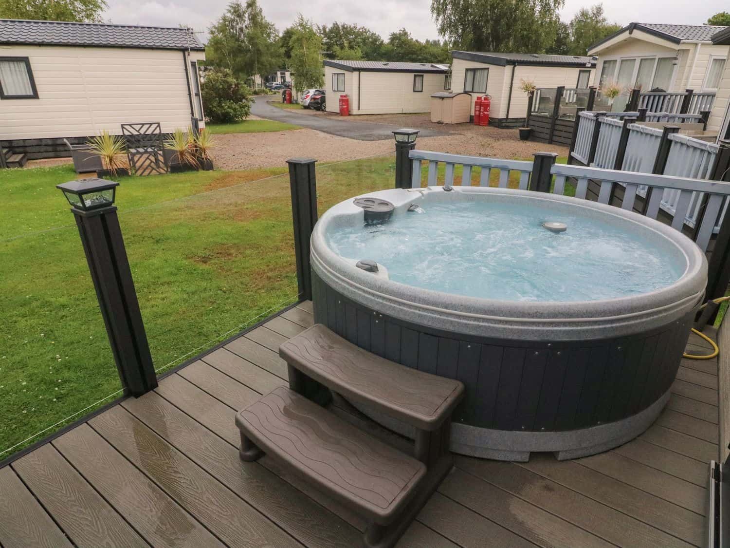 Hot tub on the deck with water views at Waterside Lodge