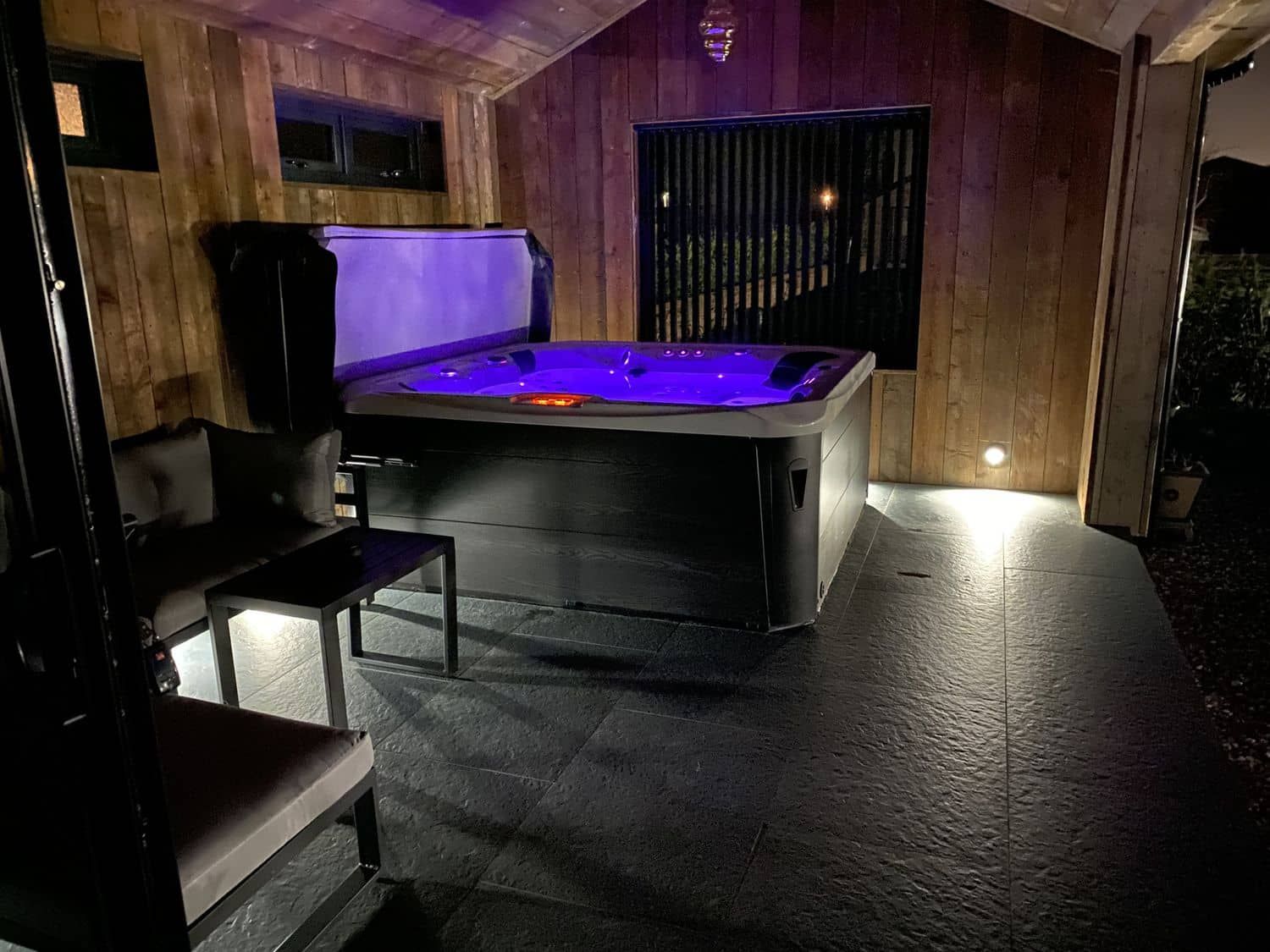 Covered outdoor hot tub for relaxation at Wayside Lodge