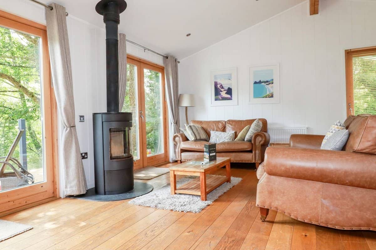 Modern open plan living area with lake views at 6 Water's Edge