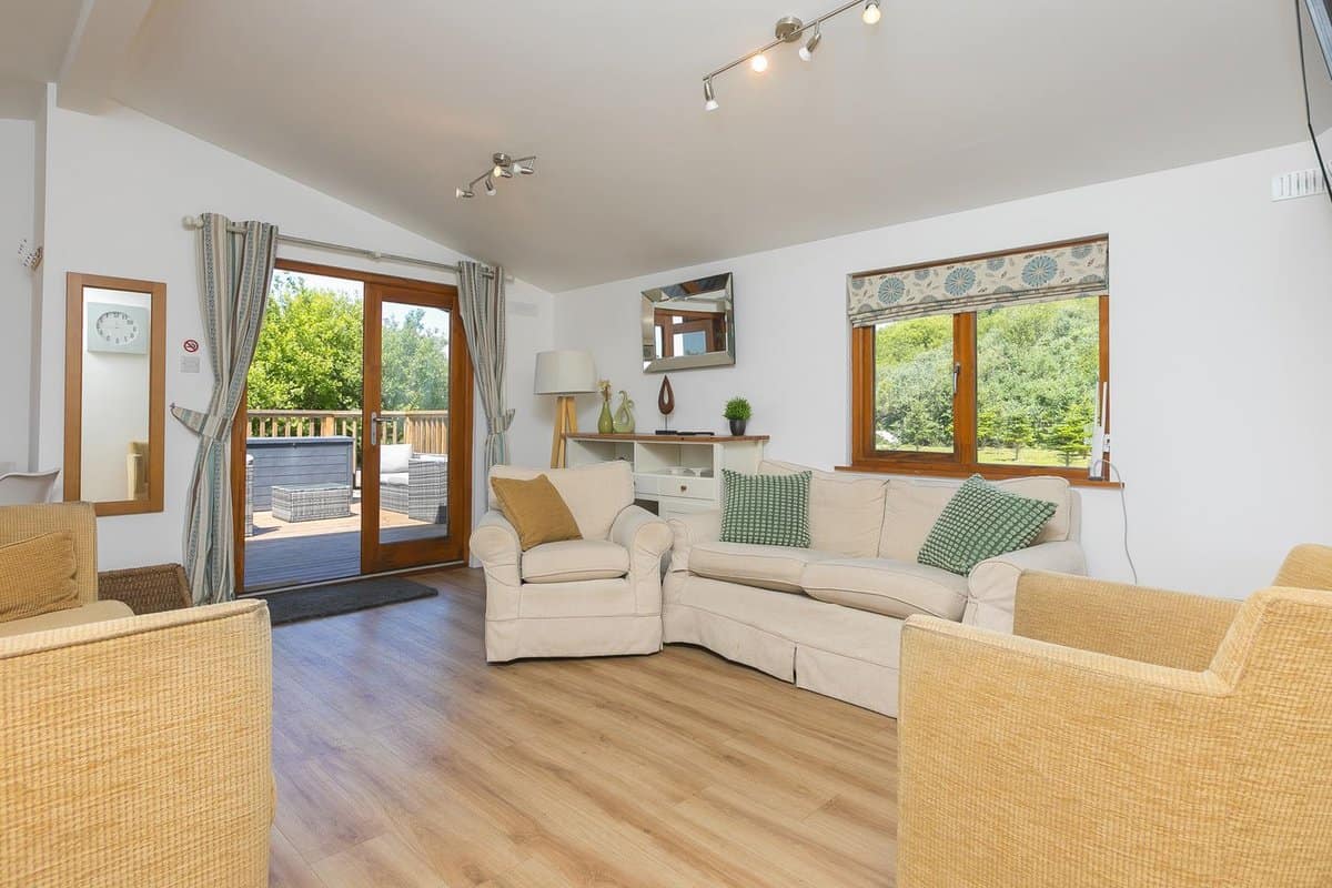 Warm wooden interior with log burner and cosy seating at Costentyn