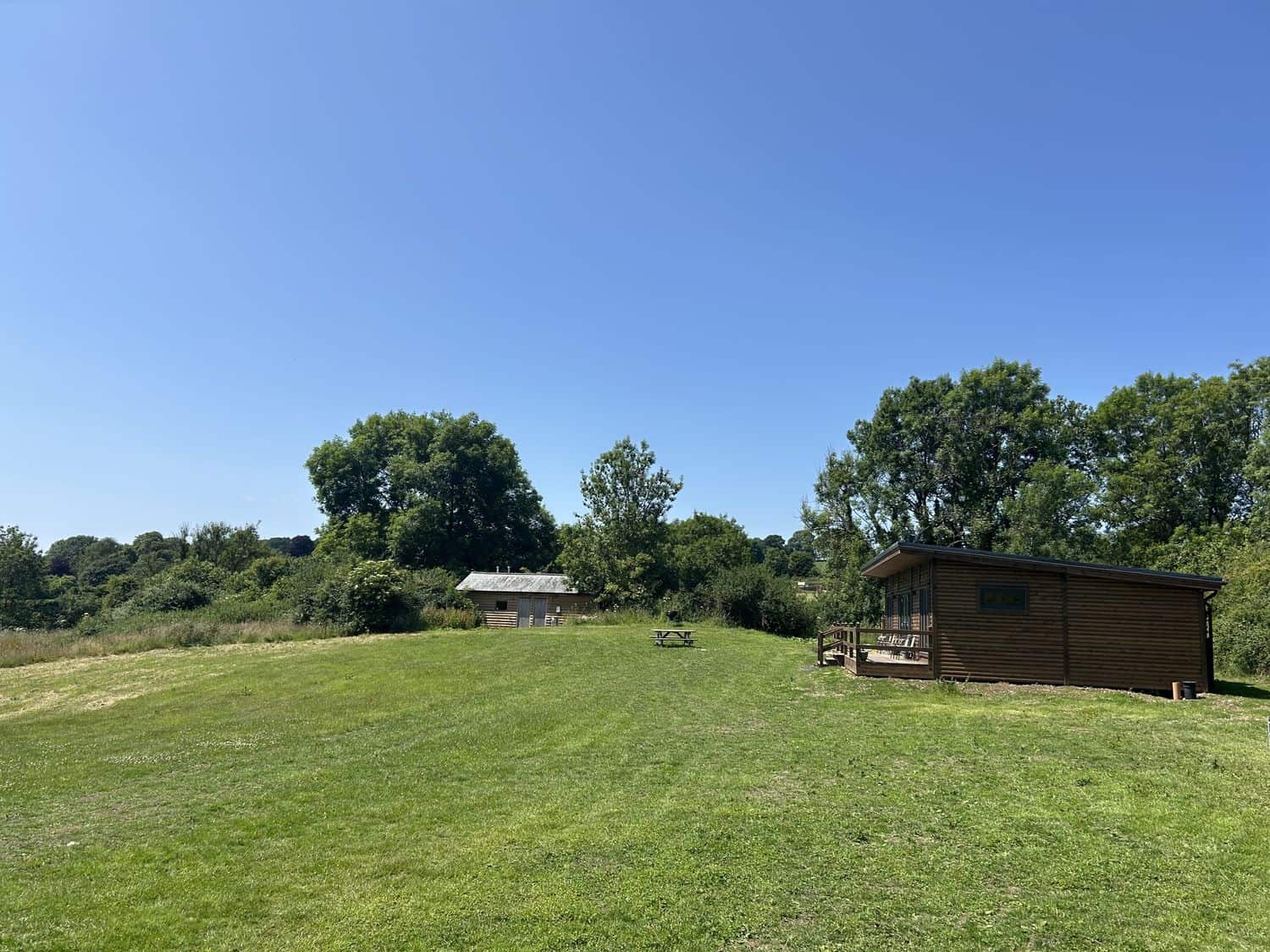 Private outdoor hot tub surrounded by greenery at Foxglove