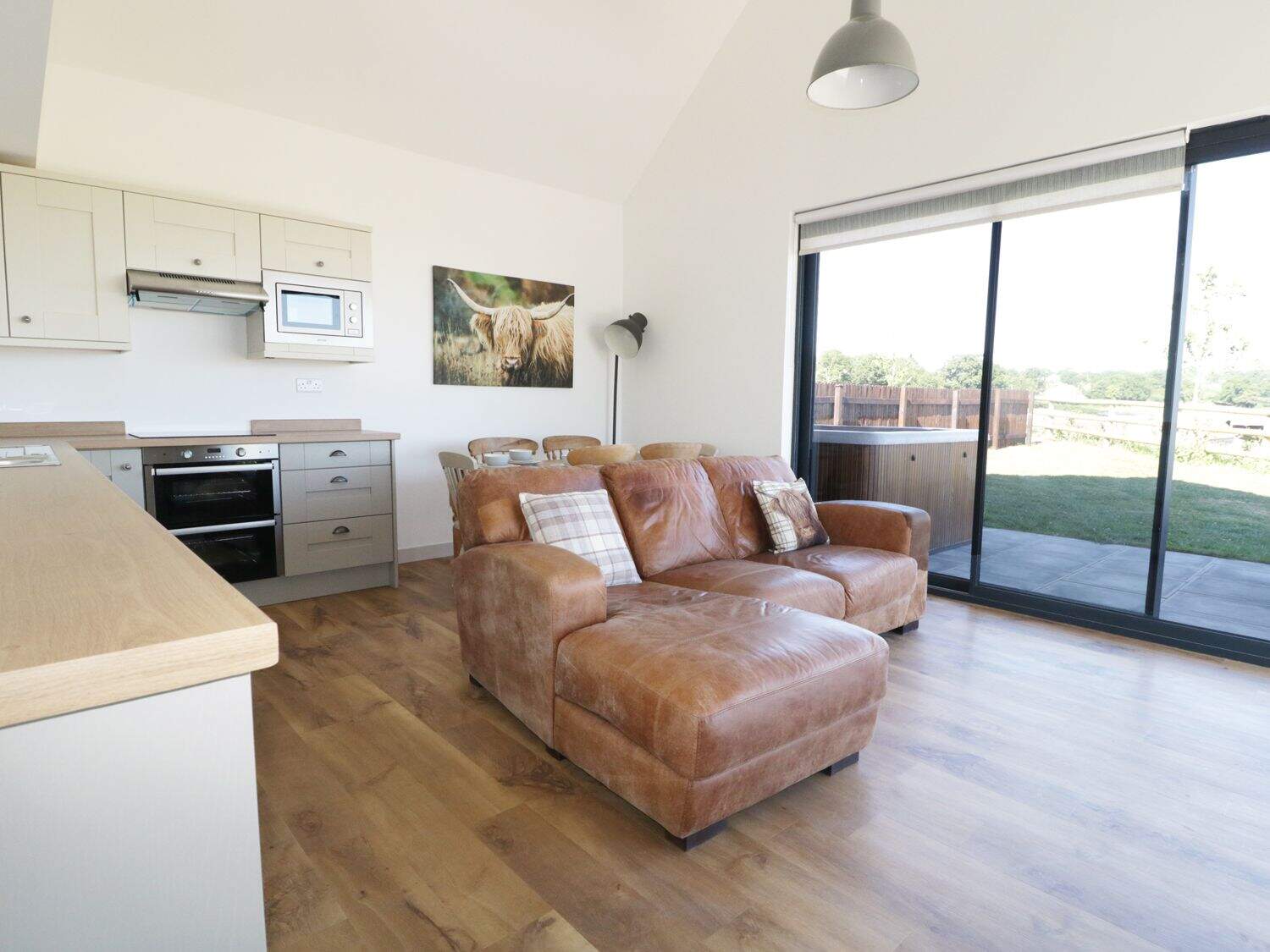 Spacious living area with comfortable seating at Heron Lodge Somerset
