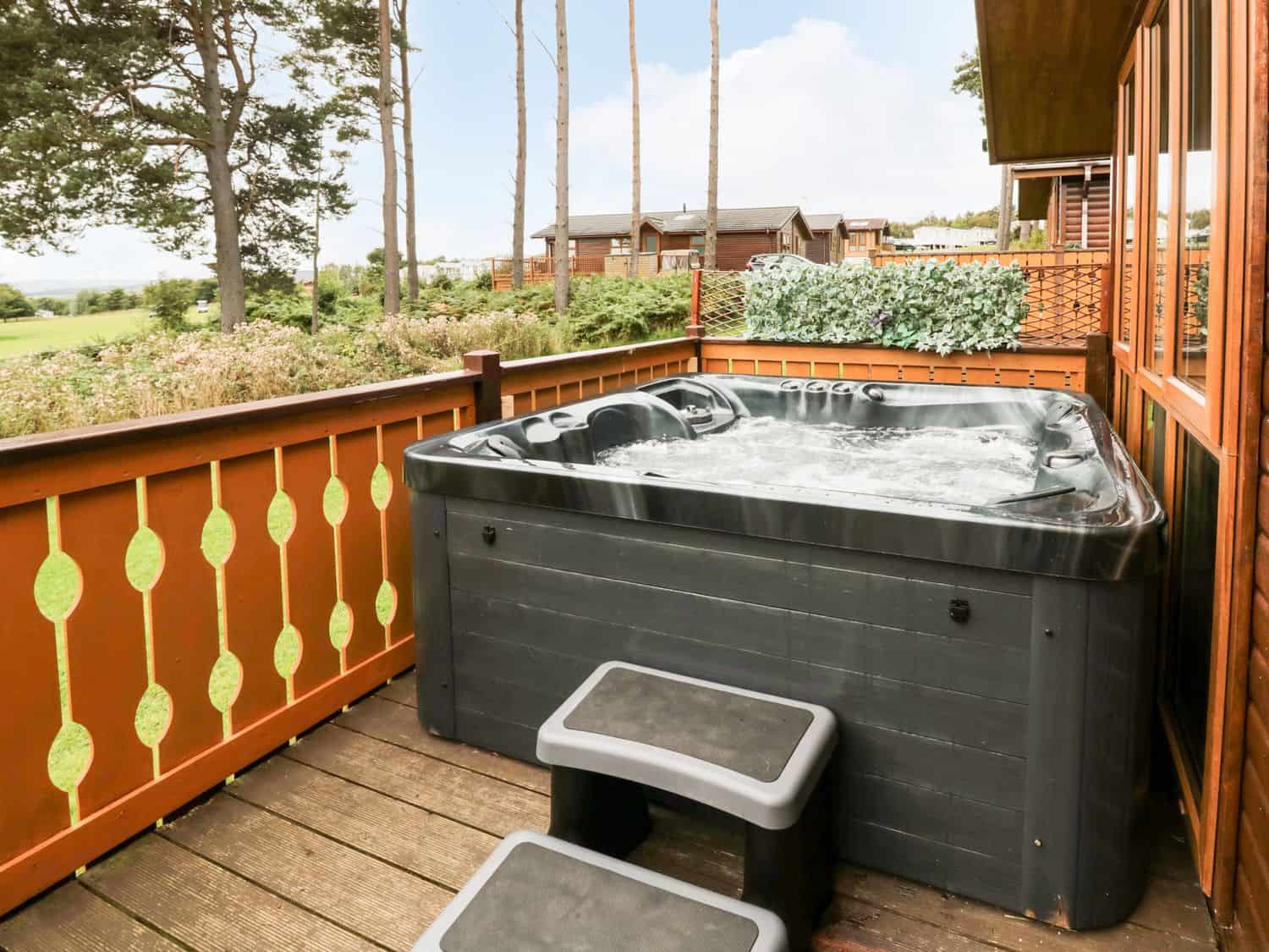 Private hot tub on deck with golf course views at Hillside View