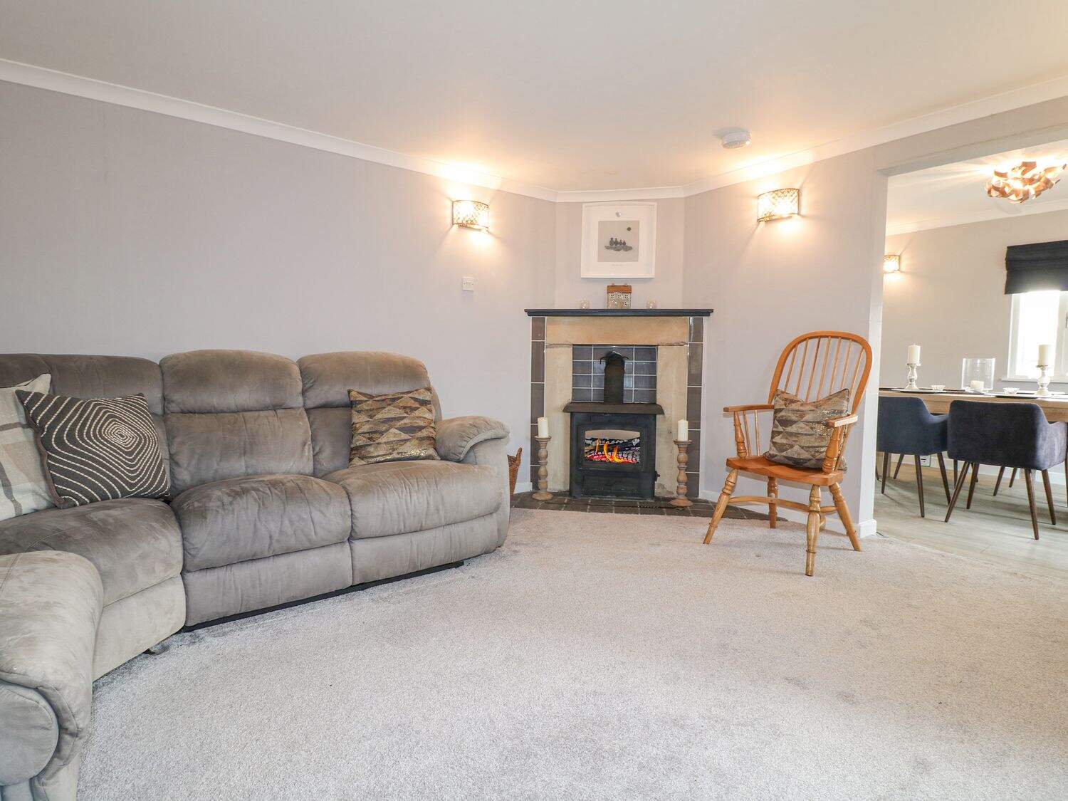 Bright open-plan living area with oak beams and cosy furnishings at The Lodge At Wildersley Farm