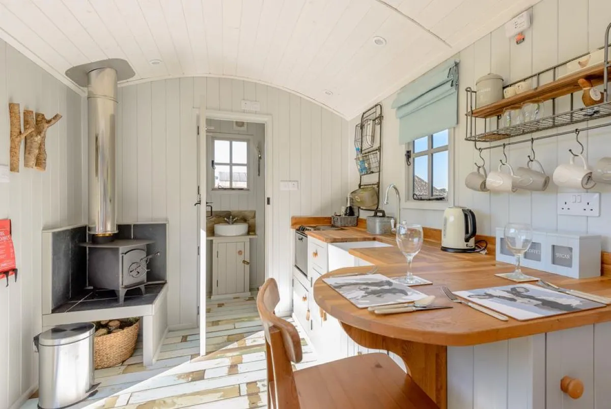 Cosy interior with woodburner at The Hut at Hole Farm