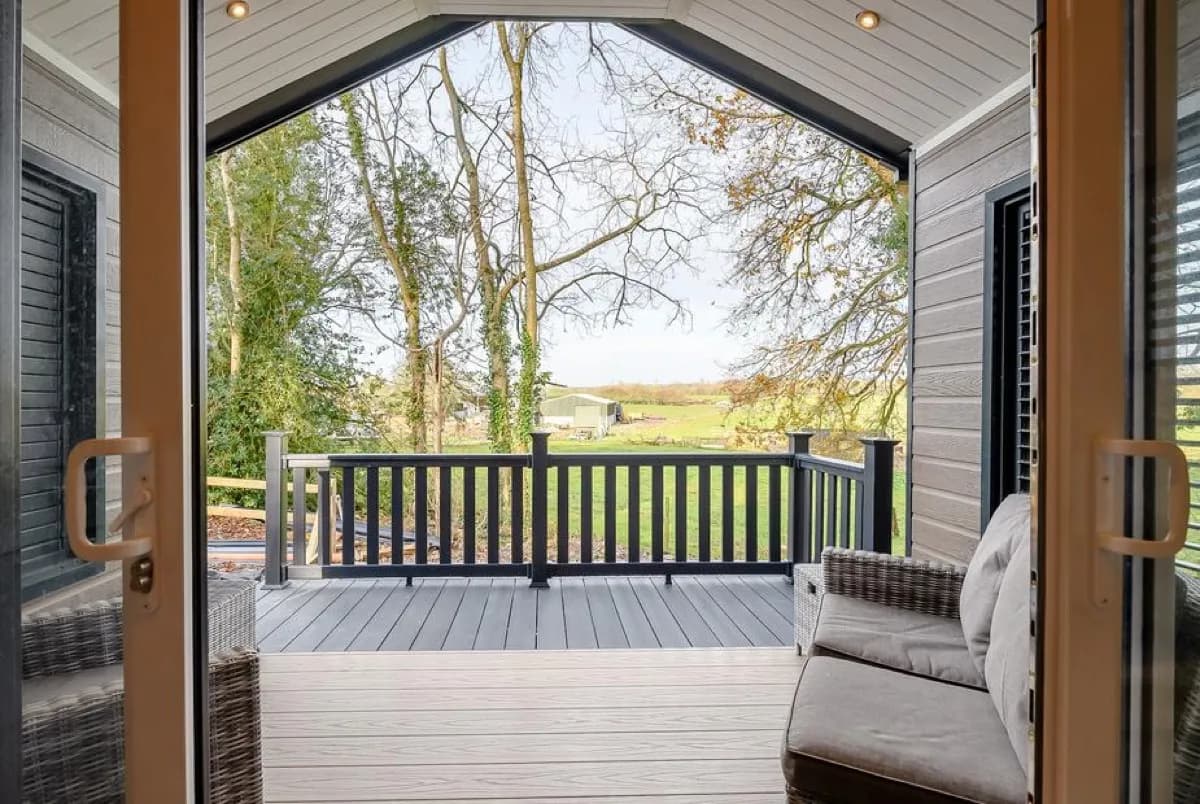 Private hot tub on wooden deck at Woodpecker Lodge